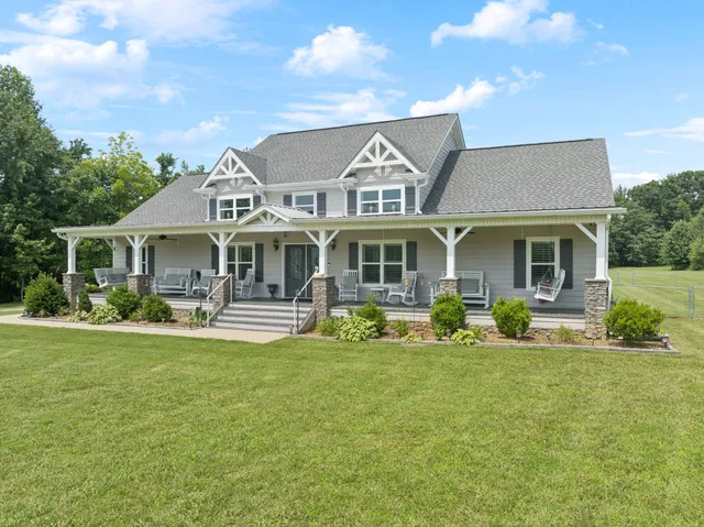 a front view of a house with swimming pool and yard