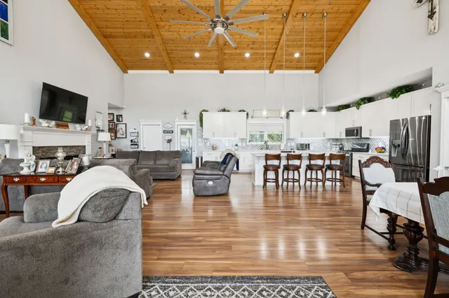a living room with lots of furniture and kitchen view