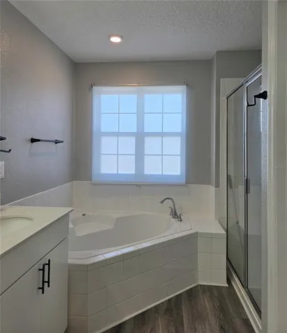 a bathroom with a bathtub and a sink