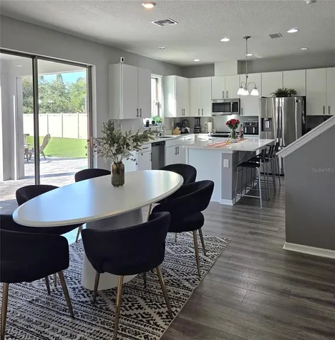 a view of a dining room with furniture window and wooden floor