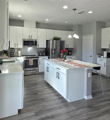 a kitchen with cabinets a sink and appliances