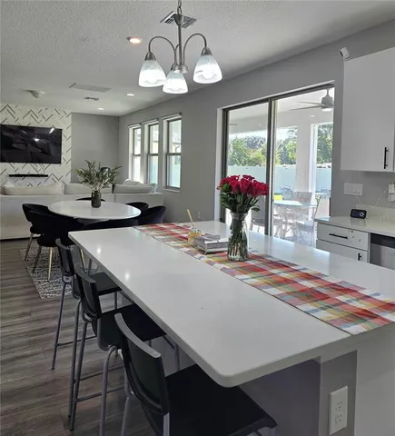 a view of a dining room with furniture wooden floor and chandelier