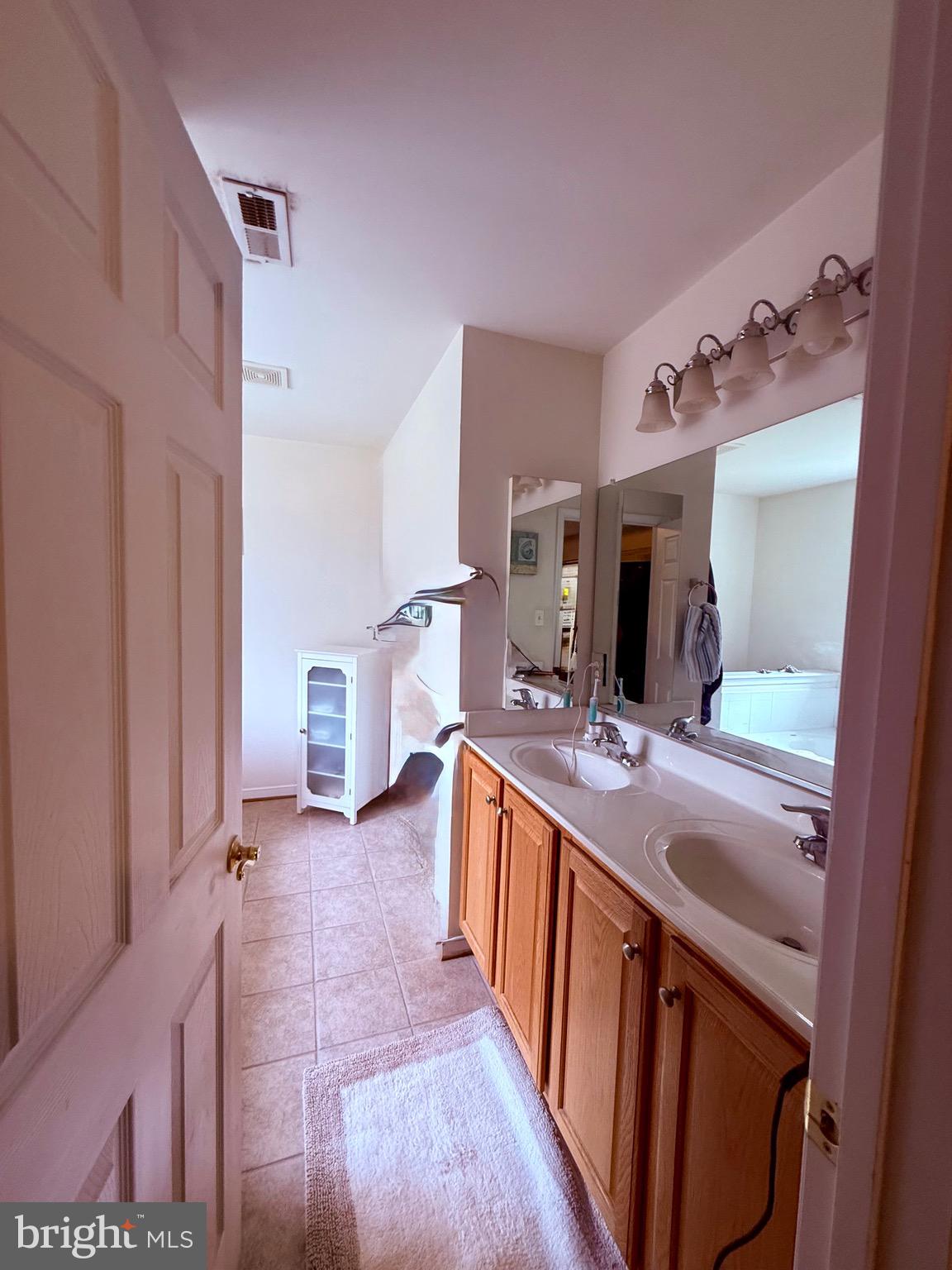 10715 Blackthorn Lane Henrico, VA 23233 - Photo 9 of 16 a bathroom with a sink double vanity