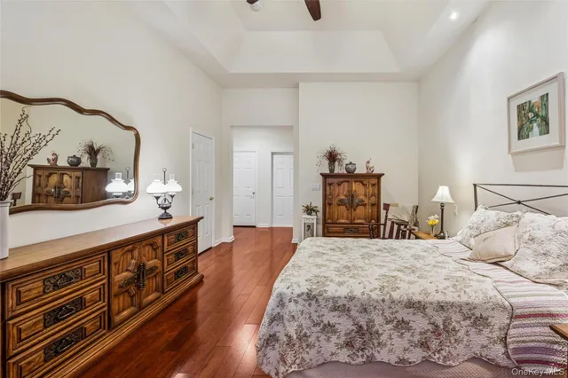 a large bedroom with a bed and wooden floor