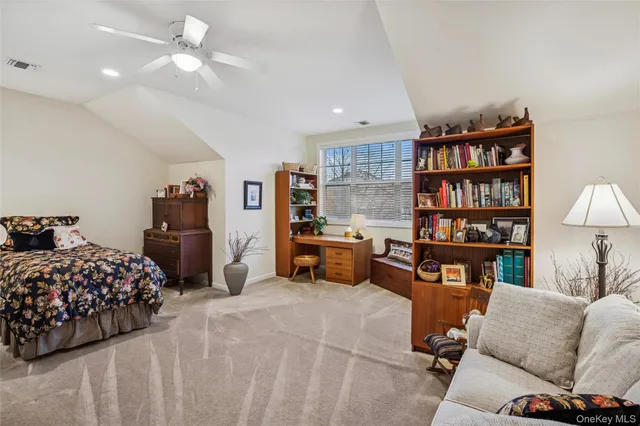 a bedroom with furniture and a book shelf