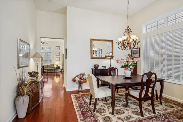 a view of a dining room with furniture wooden floor and chandelier