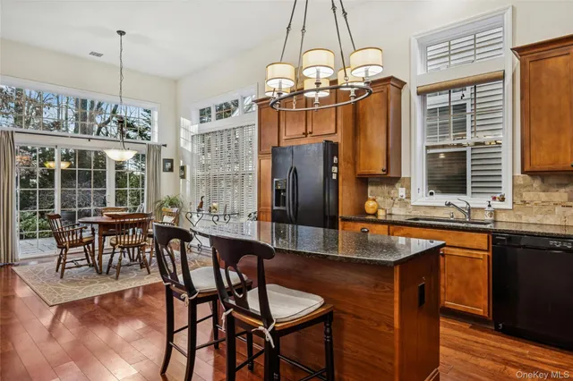 a dining table with chairs and chandelier