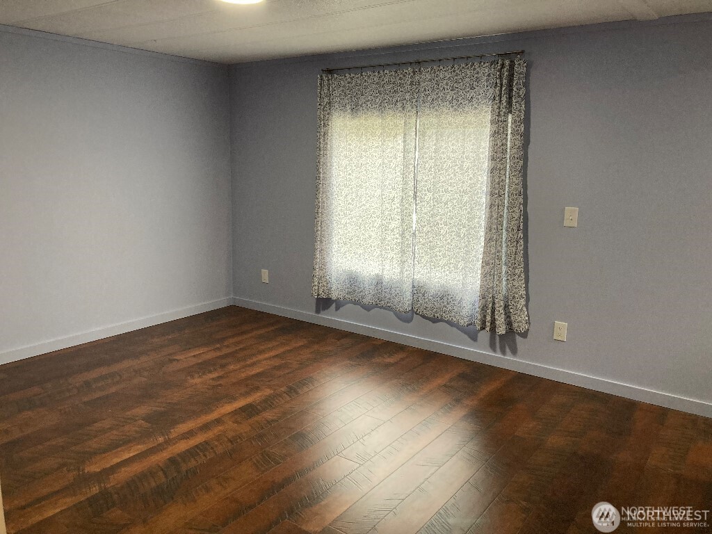 26506 Ridge Avenue Ocean Park, WA 98640 - Photo 18 of 28 an empty room with wooden floor and windows