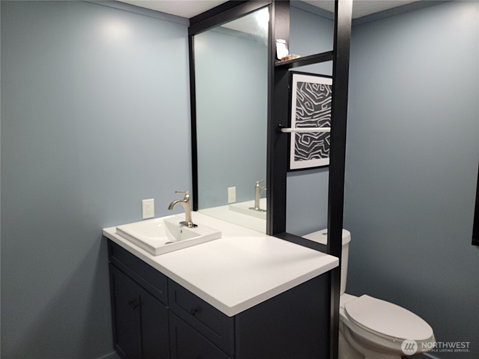 26506 Ridge Avenue Ocean Park, WA 98640 - Photo 20 of 28 a bathroom with a sink a toilet and mirror