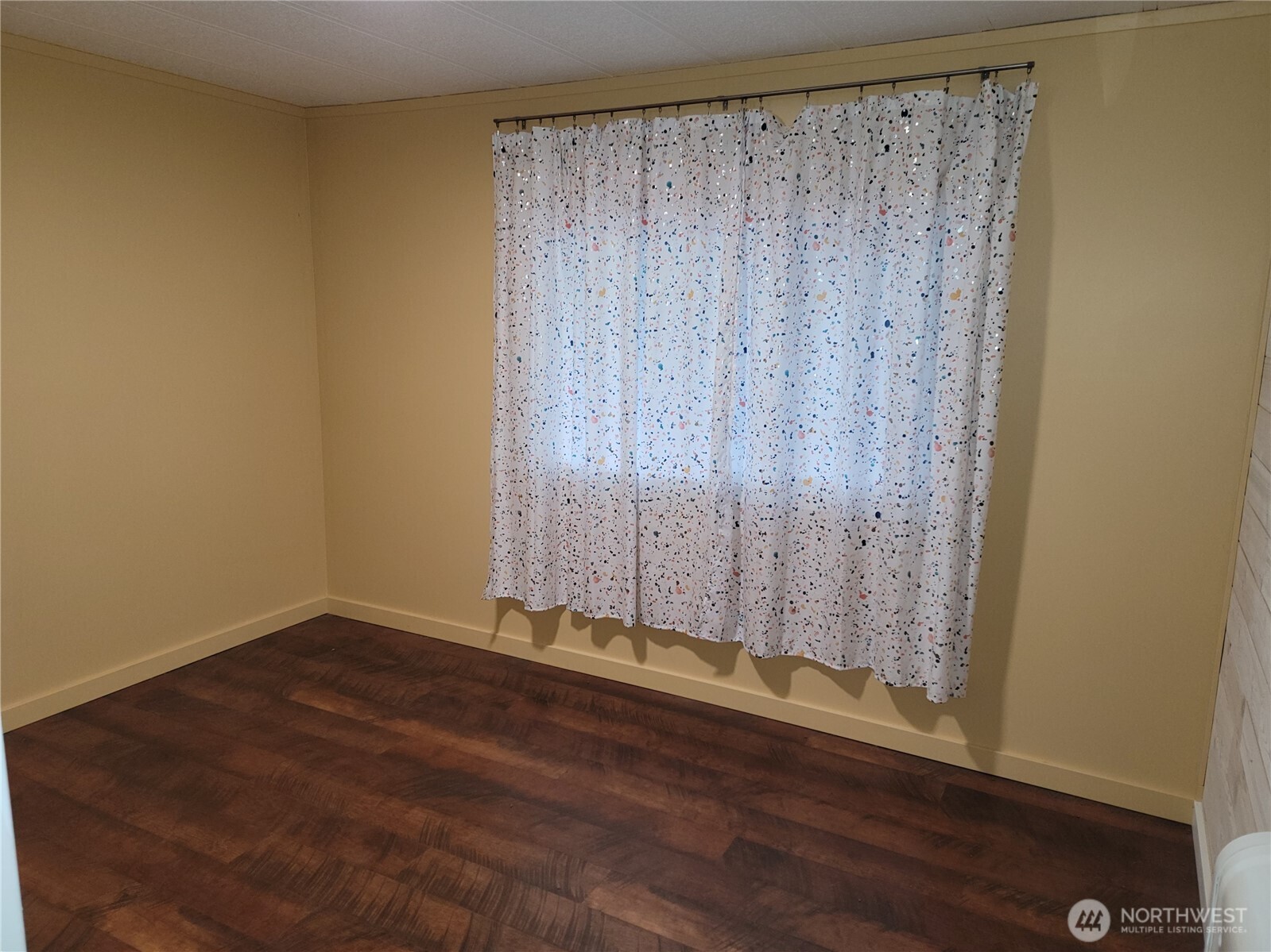 26506 Ridge Avenue Ocean Park, WA 98640 - Photo 24 of 28 a view of a room with wooden floor and a window