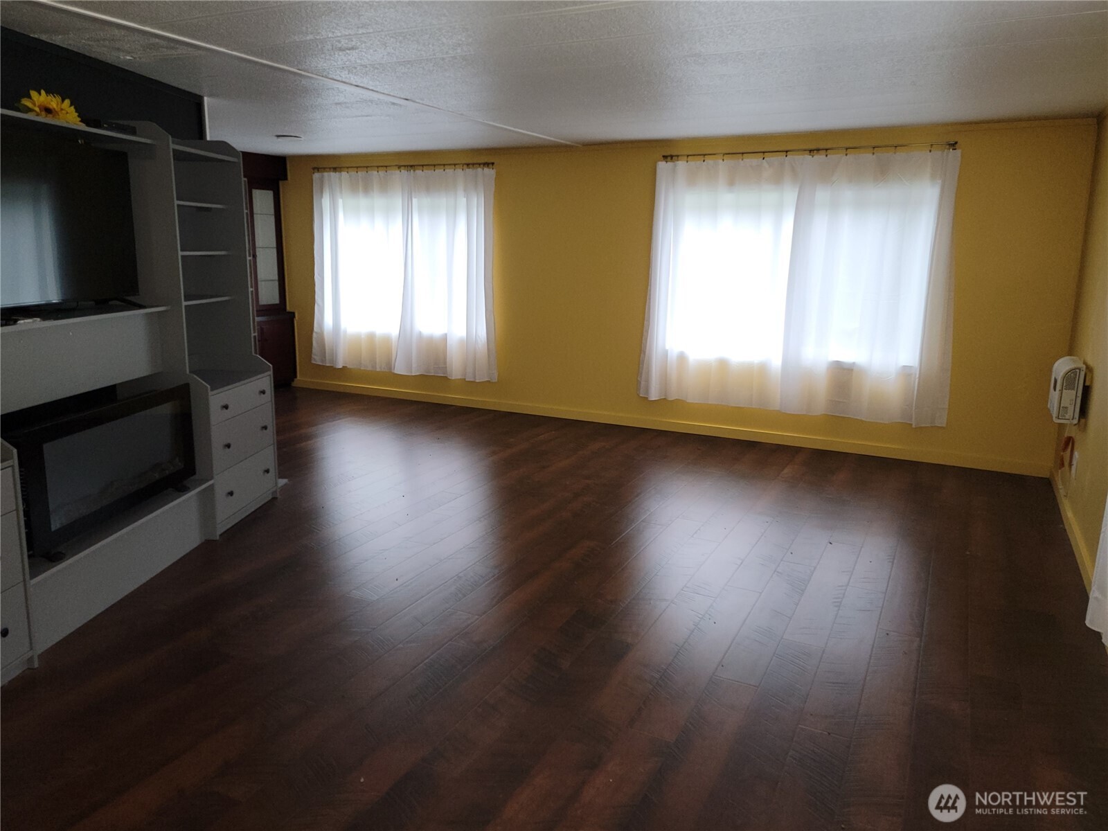 26506 Ridge Avenue Ocean Park, WA 98640 - Photo 9 of 28 an empty room with wooden floor and windows
