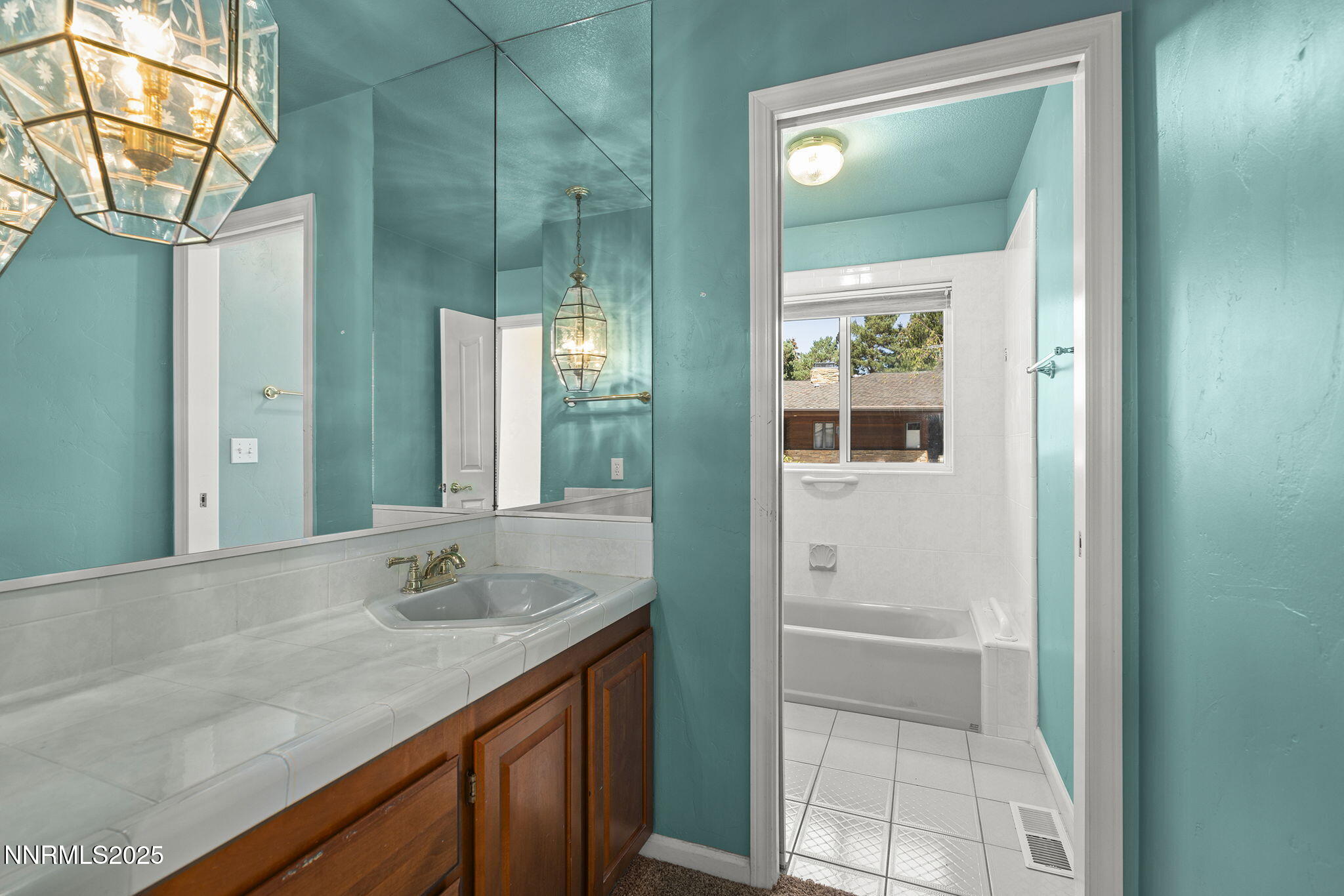 2820 East Lake Ridge Reno, NV 89519 - Photo 13 of 42 a bathroom with a granite countertop sink and mirror