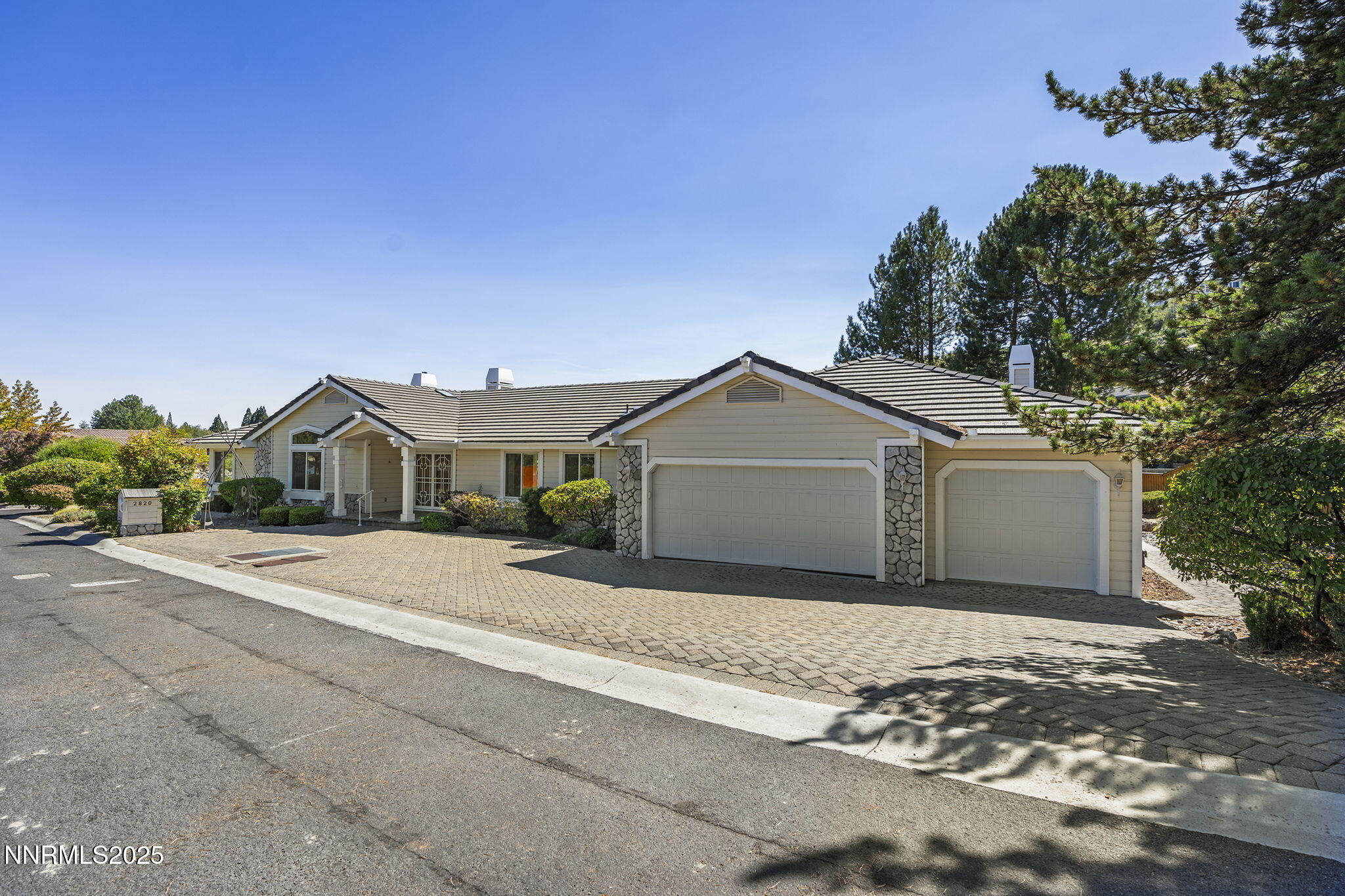2820 East Lake Ridge Reno, NV 89519 - Photo 2 of 42 a front view of a house with a yard and garage