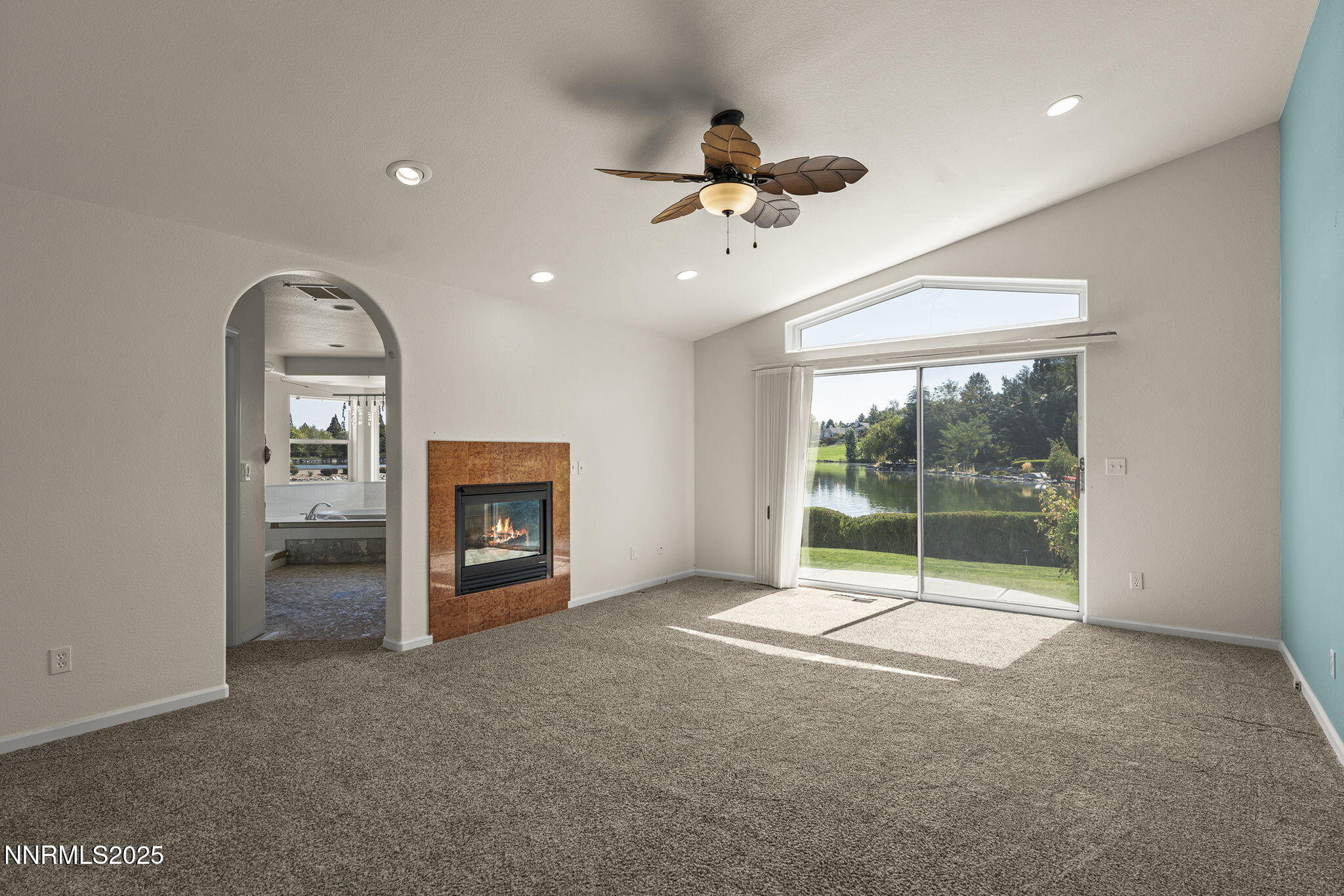 2820 East Lake Ridge Reno, NV 89519 - Photo 23 of 42 a view of an empty room with a fireplace and a large window