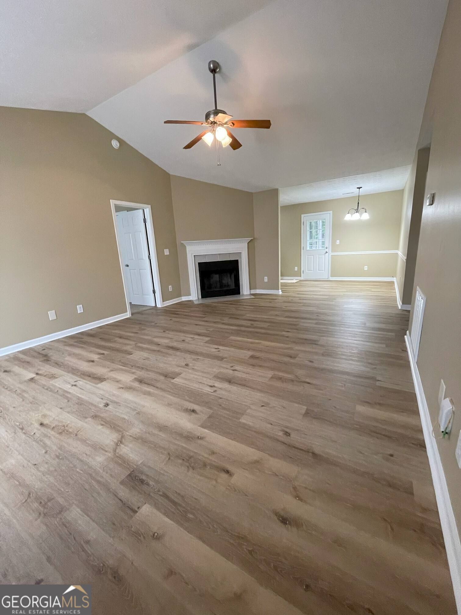 134 Cemetary Road Luthersville, GA 30251 - Photo 6 of 18 a view of an empty room with wooden floor and a fireplace
