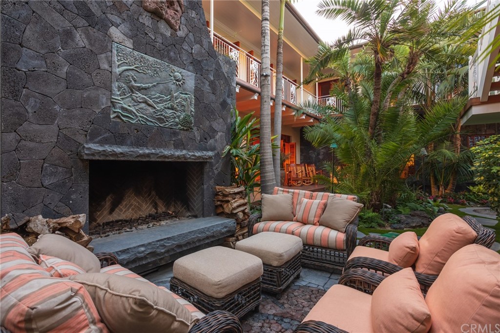 35475 Beach Road Dana Point, CA 92624 - Photo 34 of 59 a view of a patio with couches table and chairs with potted plants and a fireplace