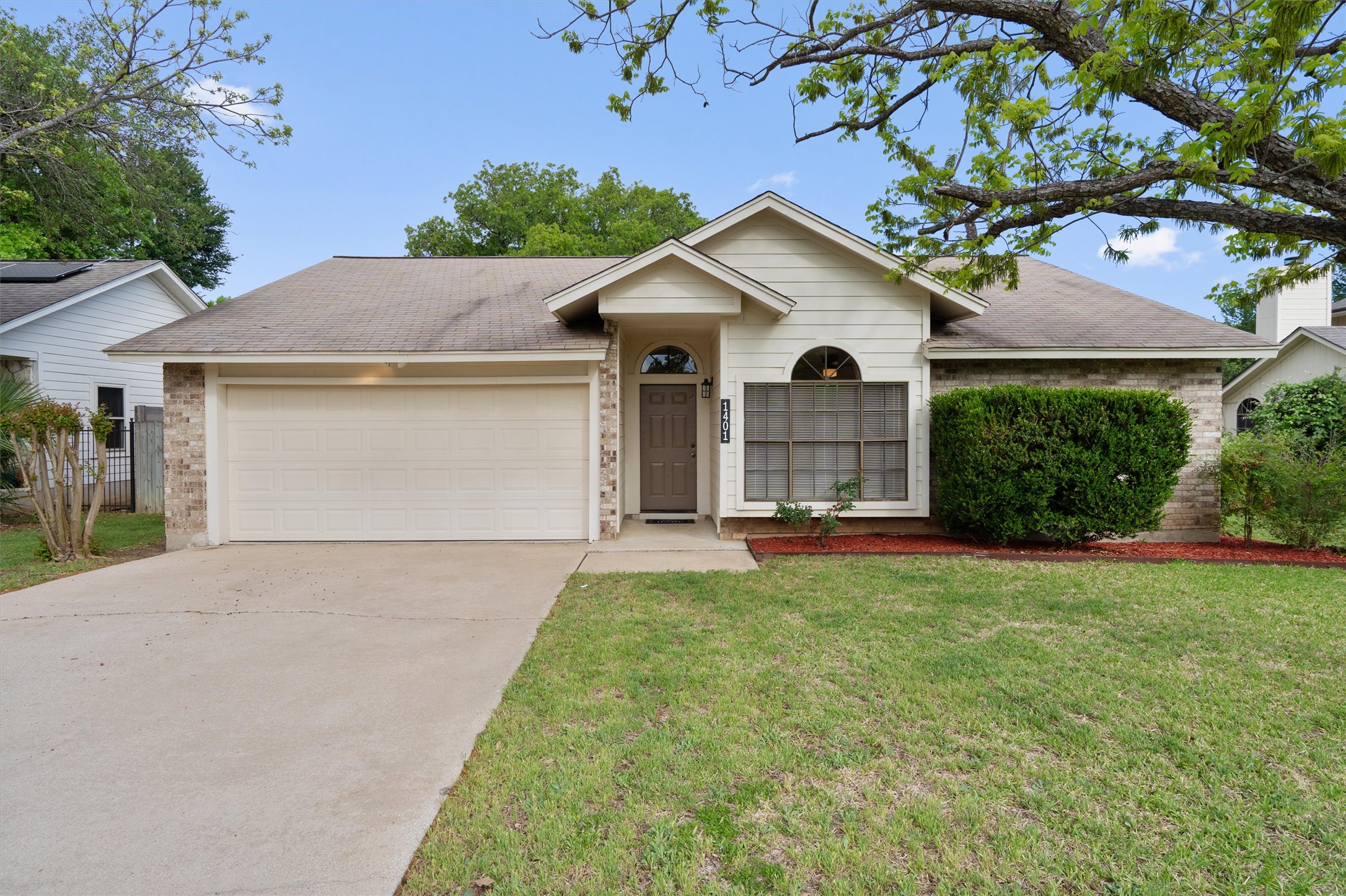 1401 Plum Creek Road Cedar Park, TX 78613 - Photo 1 of 1 Ranch-style house featuring brick siding, roof with shingles, a garage, concrete driveway, and a front yard