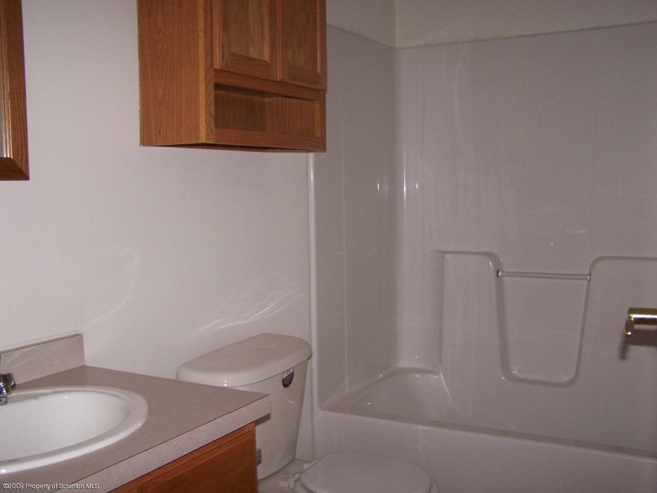 180 Niemchik Road Hunlock Creek, PA 18621 - Photo 8 of 16 a bathroom with a sink a toilet and a mirror