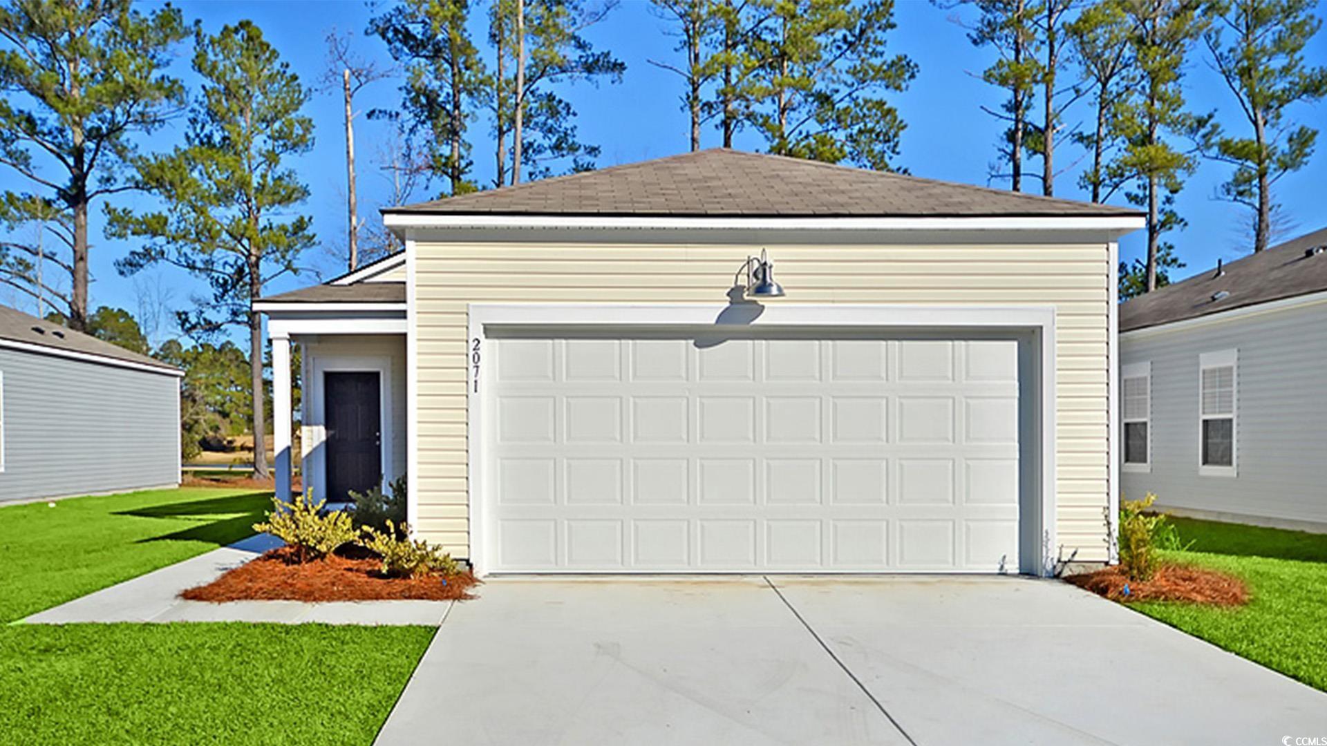 246 Warner Xing Way Loris, SC 29569 - Photo 3 of 20 Garage with a lawn