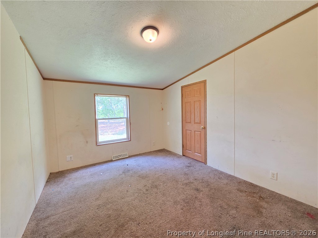 124 Franklin Road Raeford, NC 28376 - Photo 10 of 15 an empty room with windows
