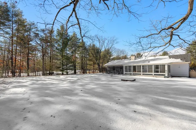 a view of a house with large trees