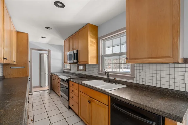 a kitchen with a sink and a refrigerator