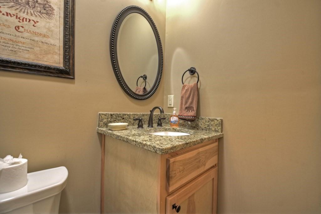 33 Carley Drive Morganton, GA 30560 - Photo 39 of 54 a bathroom with a granite countertop sink and a mirror