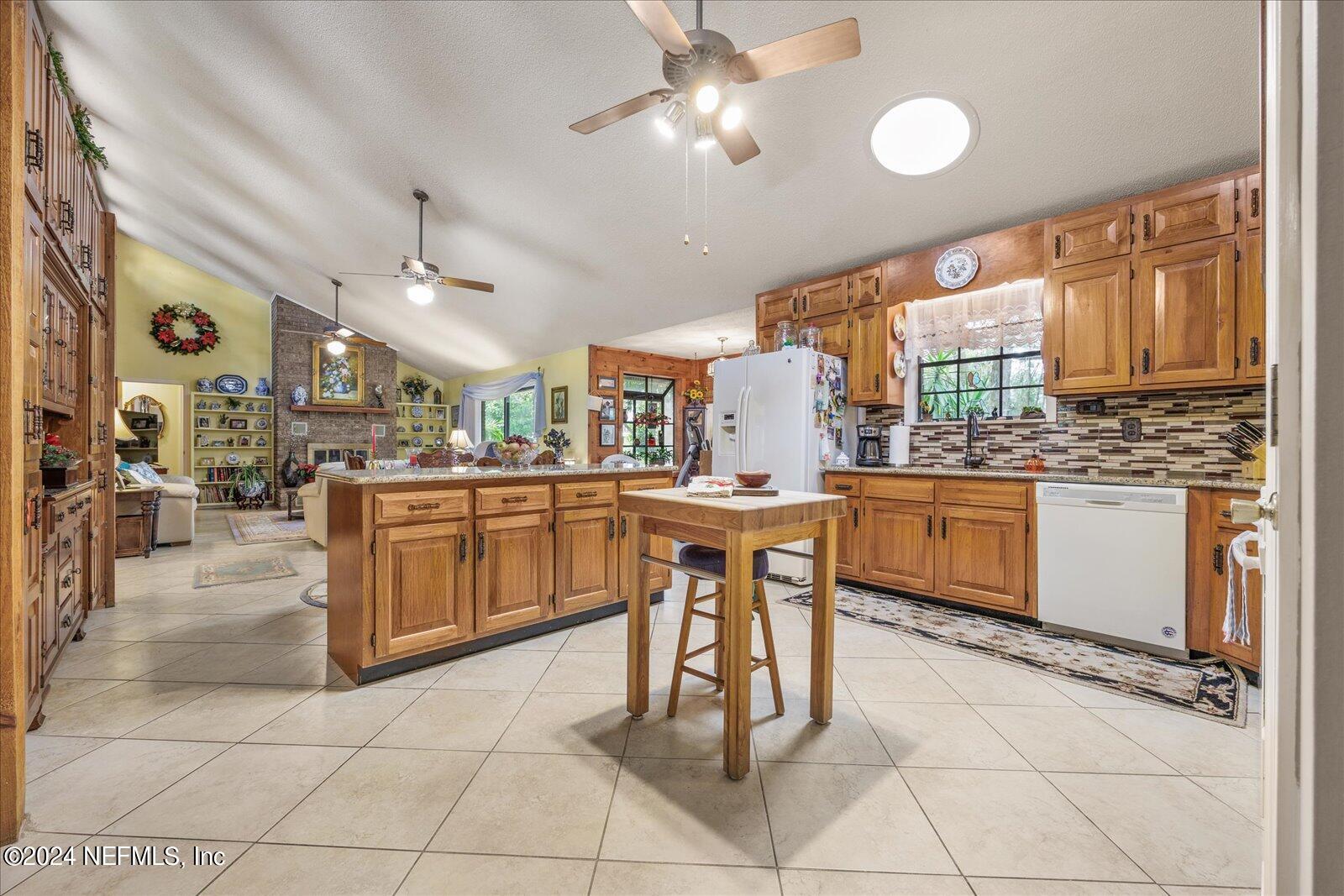 195 Horseman Club Road Palatka, FL 32177 - Photo 11 of 58 a kitchen with a sink a counter top space cabinets stainless steel appliances and a large window