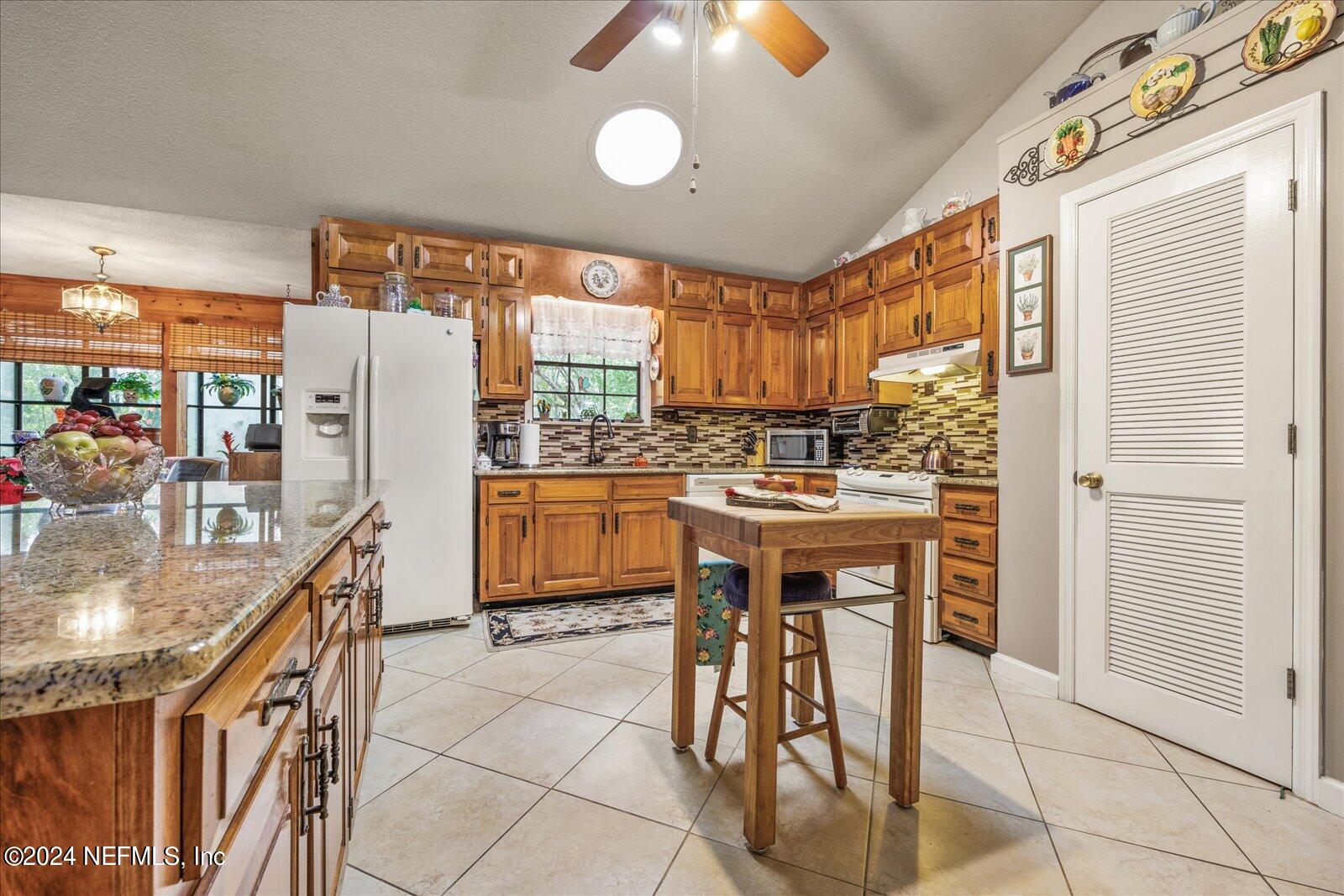 195 Horseman Club Road Palatka, FL 32177 - Photo 12 of 58 a kitchen with a sink a counter top stainless steel appliances and cabinets