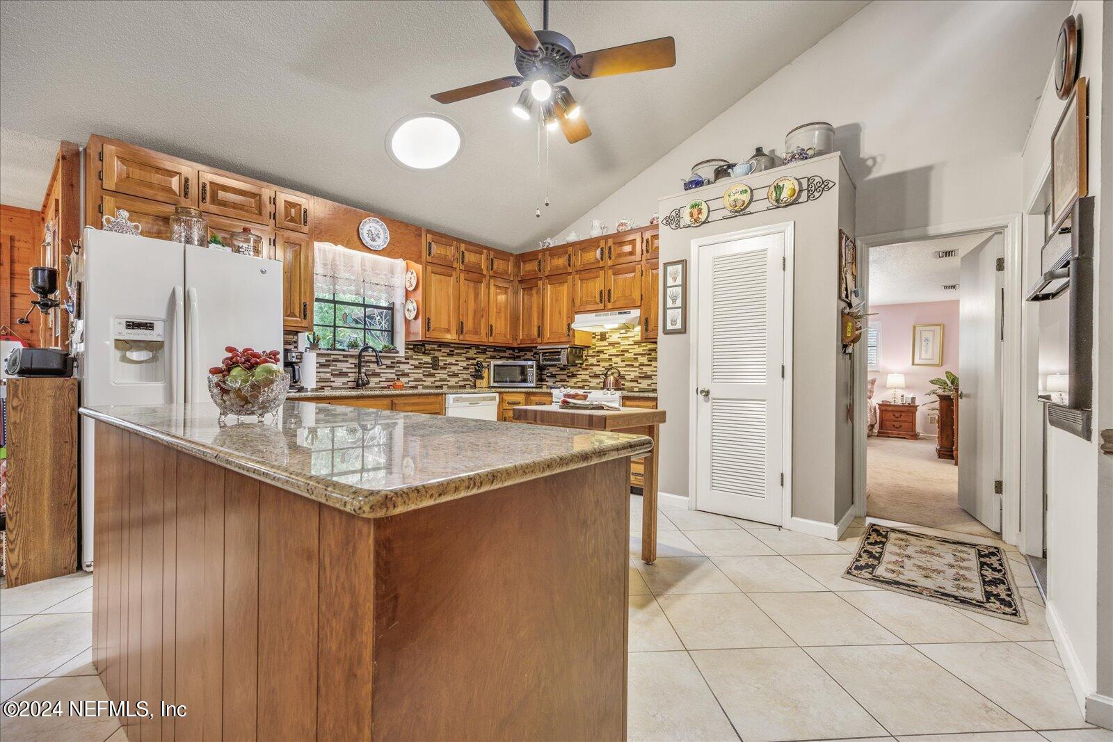 195 Horseman Club Road Palatka, FL 32177 - Photo 13 of 58 a kitchen with stainless steel appliances granite countertop a sink and a refrigerator