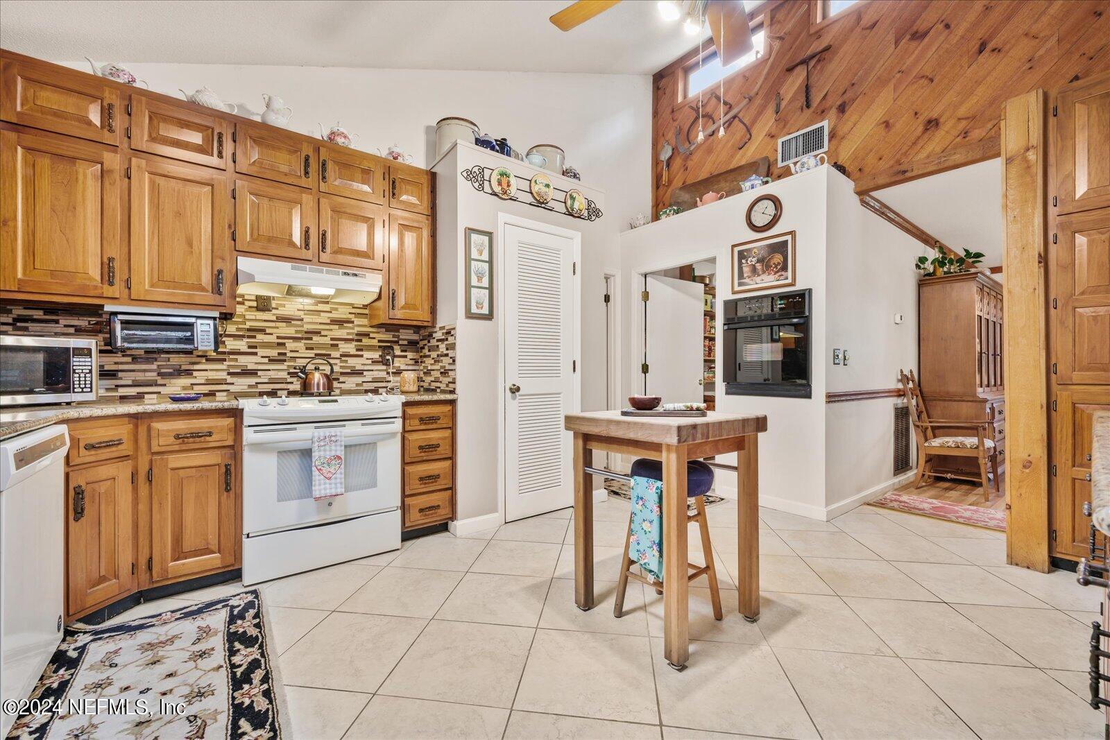 195 Horseman Club Road Palatka, FL 32177 - Photo 14 of 58 a kitchen with stainless steel appliances a stove a sink and a refrigerator