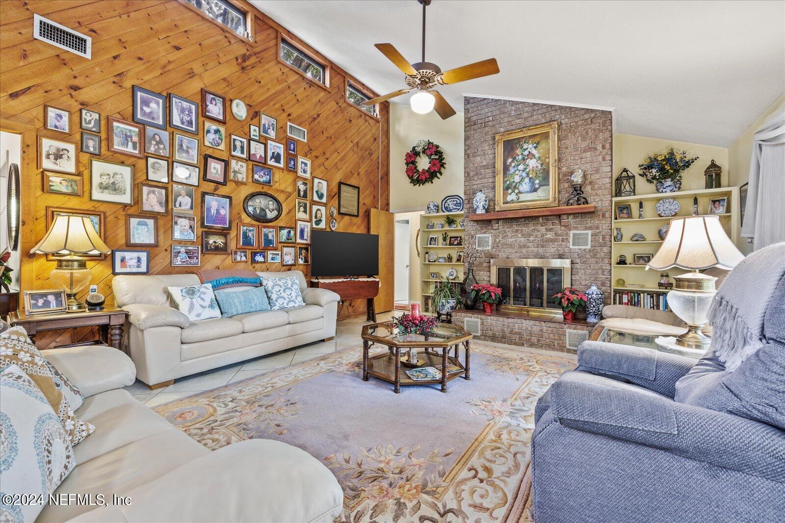 195 Horseman Club Road Palatka, FL 32177 - Photo 22 of 58 a living room with furniture a fireplace and a flat screen tv