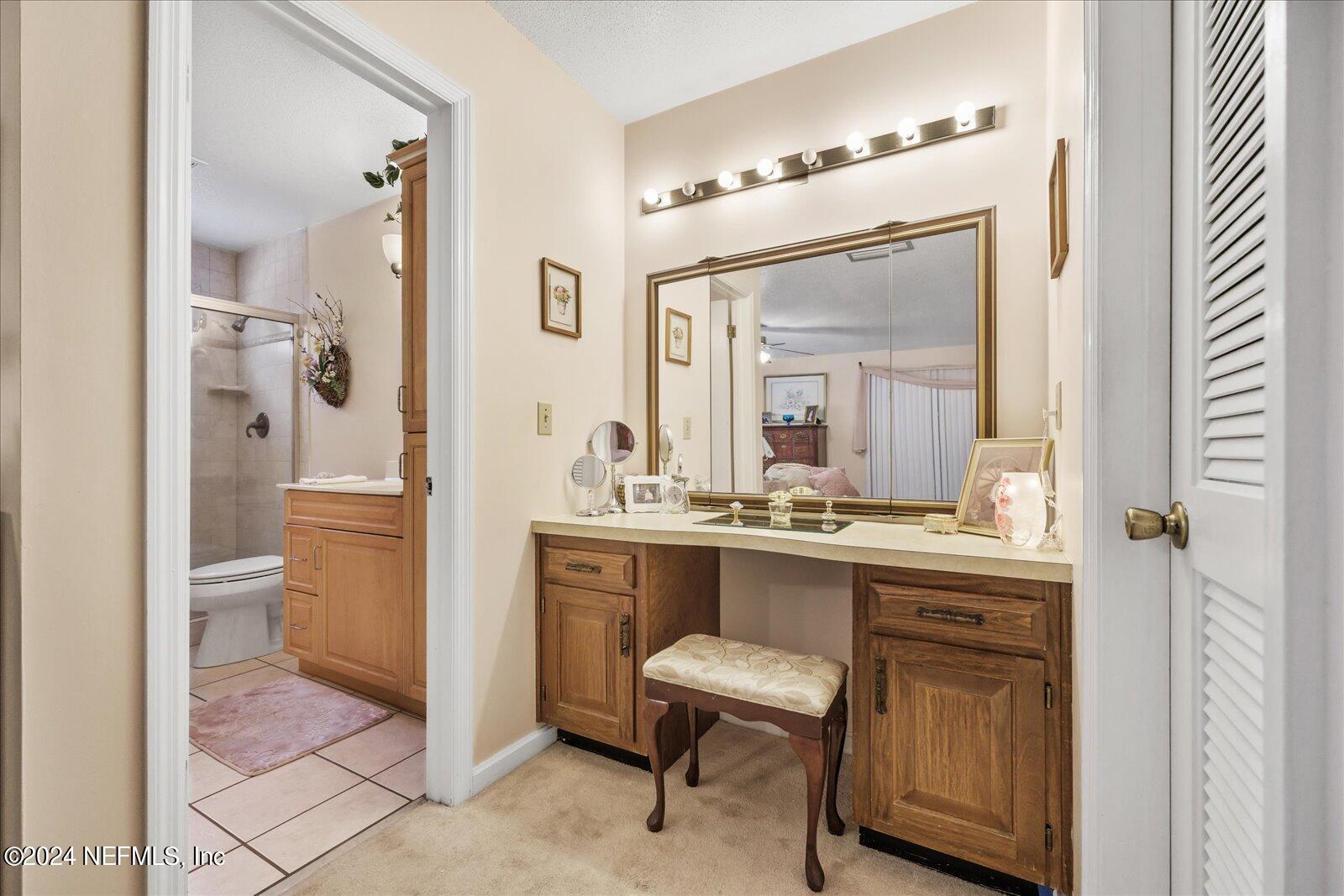 195 Horseman Club Road Palatka, FL 32177 - Photo 29 of 58 a spacious bathroom with a granite countertop sink mirror and a toilet