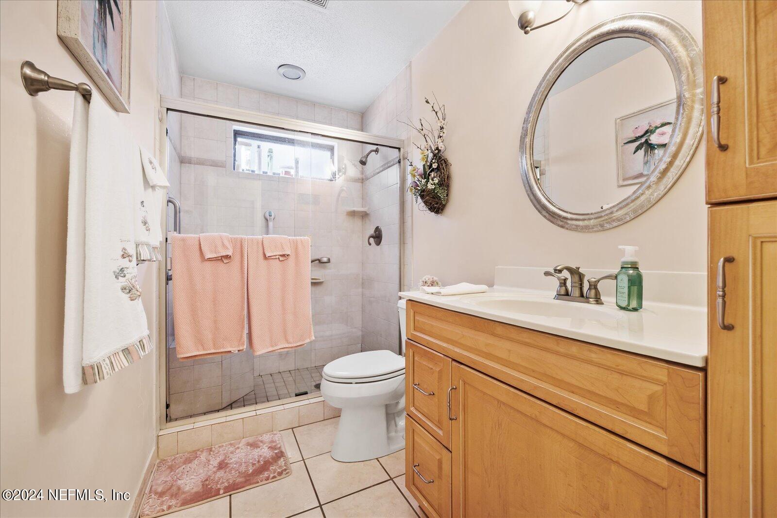 195 Horseman Club Road Palatka, FL 32177 - Photo 30 of 58 a bathroom with a granite countertop toilet sink and mirror
