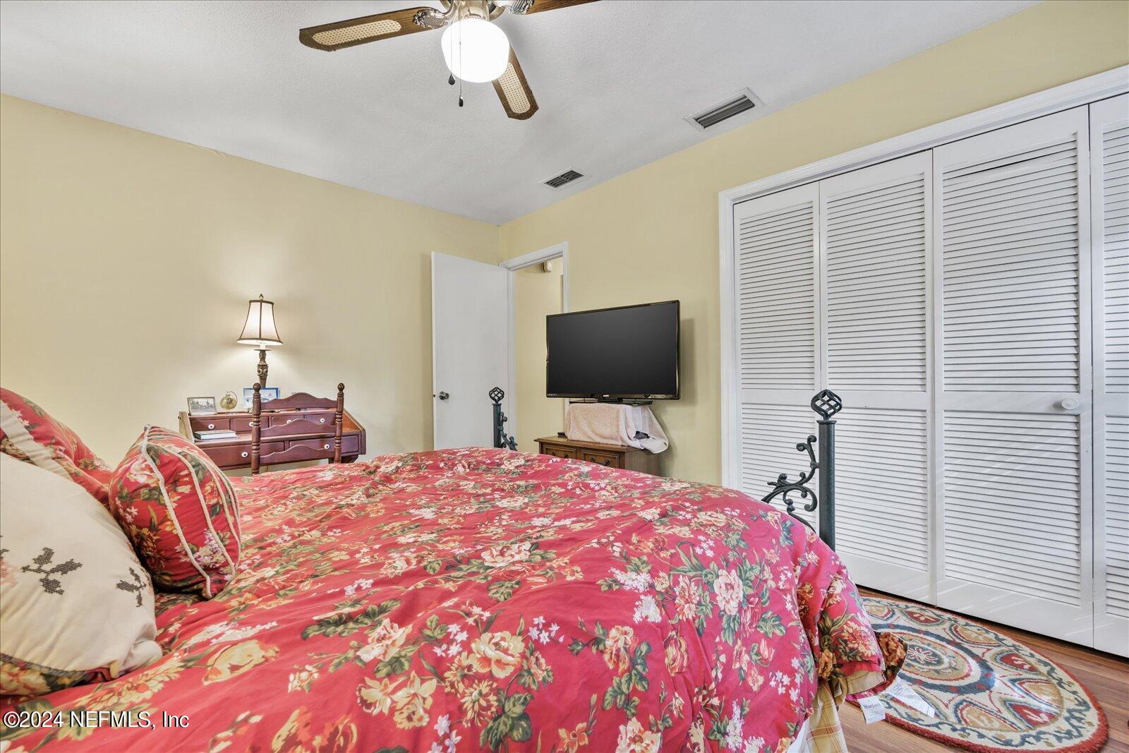 195 Horseman Club Road Palatka, FL 32177 - Photo 34 of 58 a bedroom with a bed and a flat screen tv