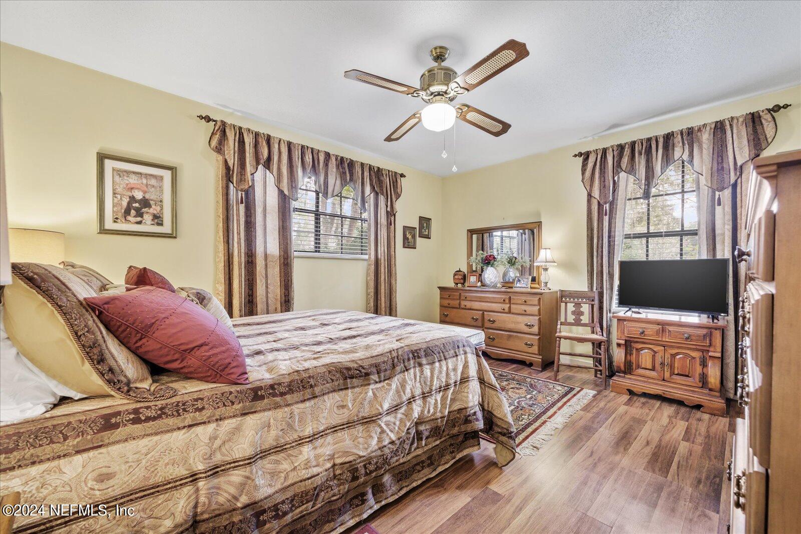 195 Horseman Club Road Palatka, FL 32177 - Photo 35 of 58 a bedroom with a large bed a flat tv screen and dresser