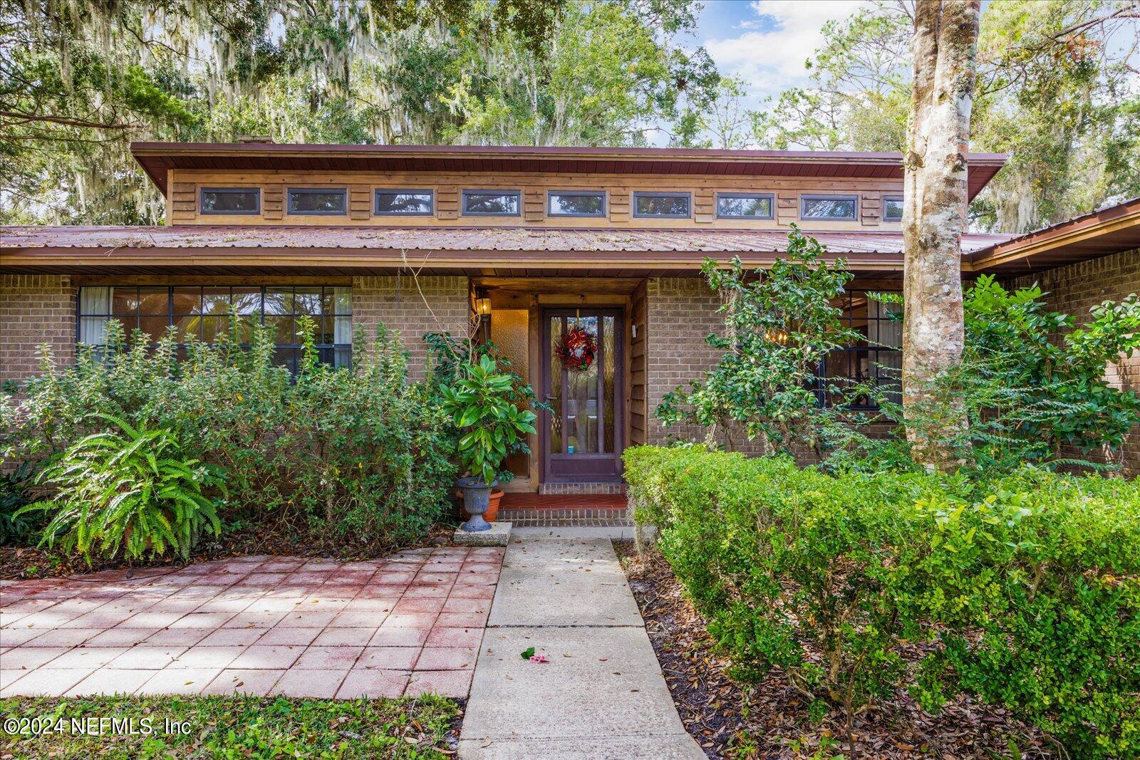 195 Horseman Club Road Palatka, FL 32177 - Photo 4 of 58 a front view of a house with garden