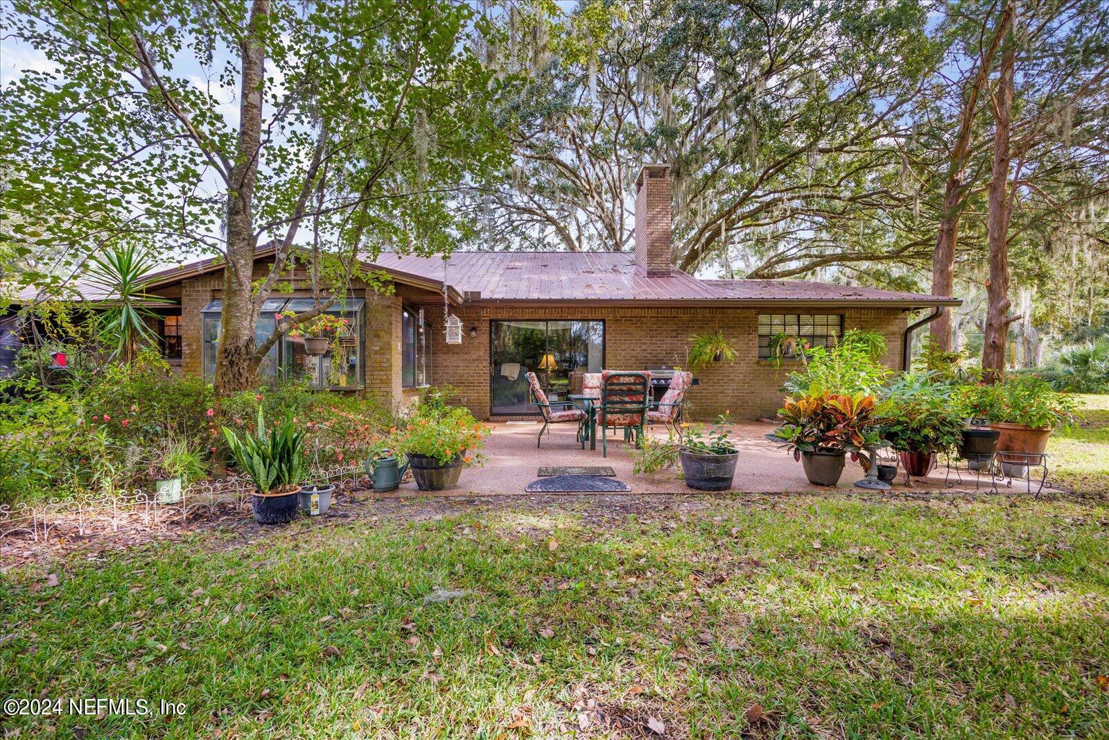 195 Horseman Club Road Palatka, FL 32177 - Photo 42 of 58 a view of a house with backyard porch and sitting area