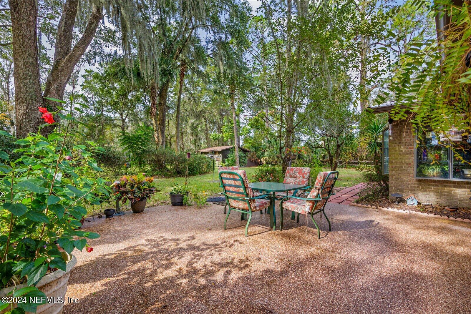 195 Horseman Club Road Palatka, FL 32177 - Photo 45 of 58 a view of a chairs and table in the backyard