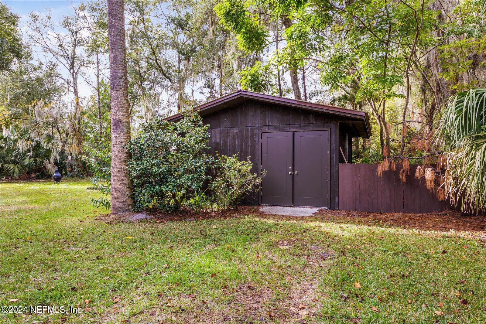 195 Horseman Club Road Palatka, FL 32177 - Photo 47 of 58 a view of backyard with large trees and plants