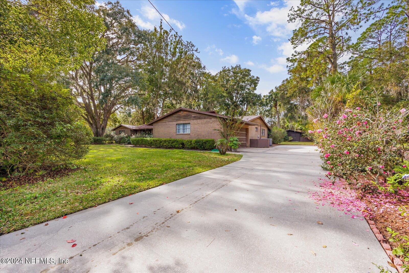 195 Horseman Club Road Palatka, FL 32177 - Photo 50 of 58 a view of house with backyard and trees