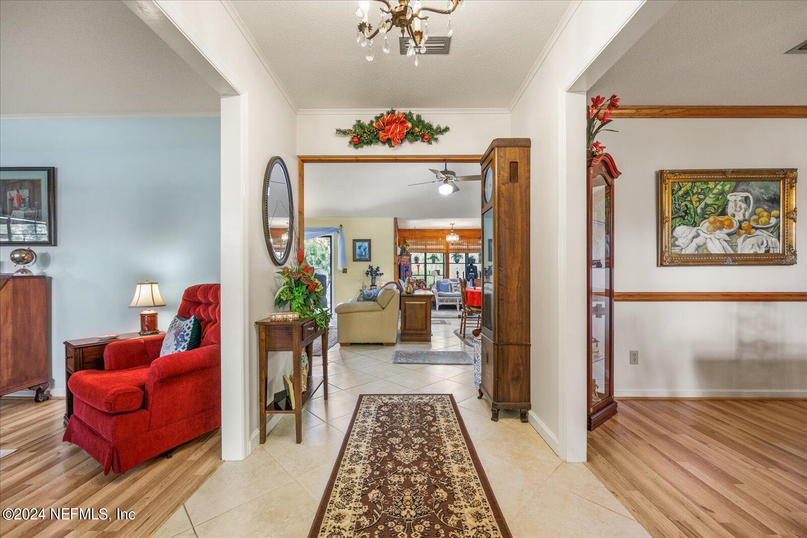 195 Horseman Club Road Palatka, FL 32177 - Photo 5 of 58 a hallway with a couch and a potted plant