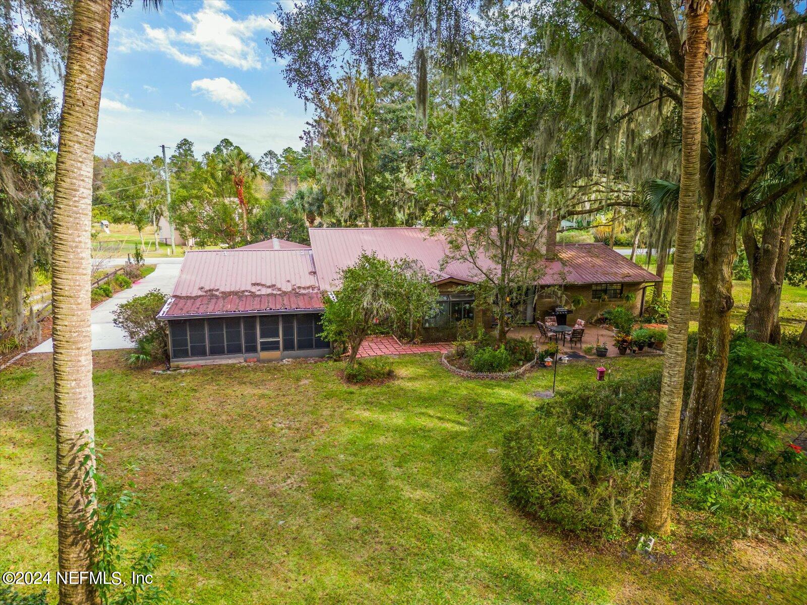 195 Horseman Club Road Palatka, FL 32177 - Photo 51 of 58 a backyard of a house with yard table and chairs