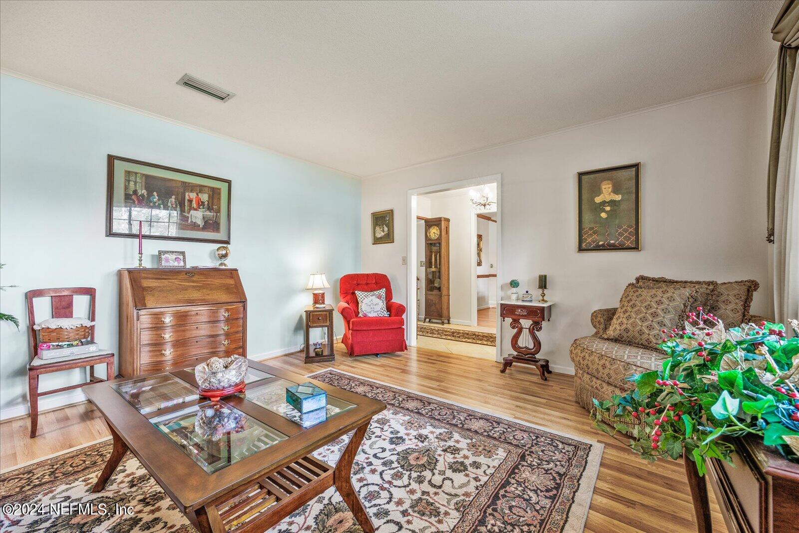 195 Horseman Club Road Palatka, FL 32177 - Photo 8 of 58 a living room with furniture and wooden floor