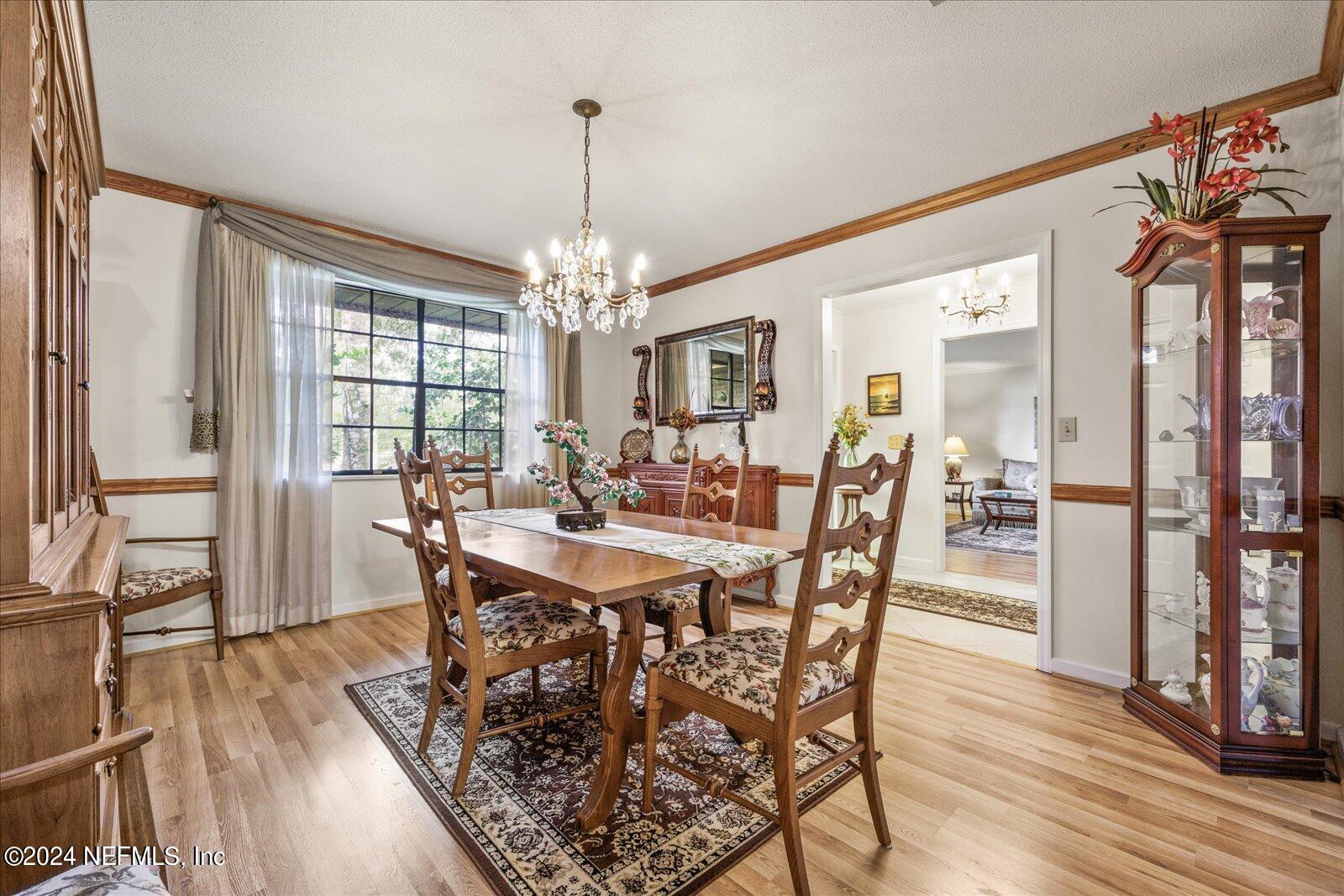 195 Horseman Club Road Palatka, FL 32177 - Photo 9 of 58 a view of a dining room with furniture window and wooden floor