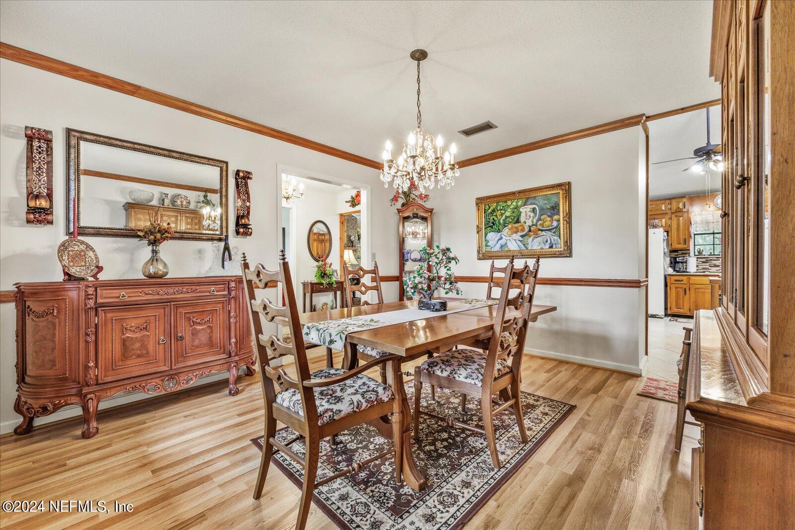 195 Horseman Club Road Palatka, FL 32177 - Photo 10 of 58 a view of a dining room with furniture window and wooden floor