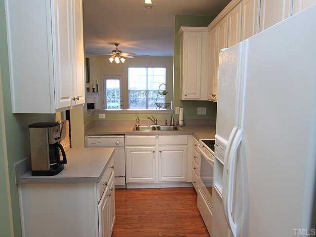 8302 City Loft Court Raleigh, NC 27613 - Photo 6 of 10 a kitchen with a sink cabinets and window