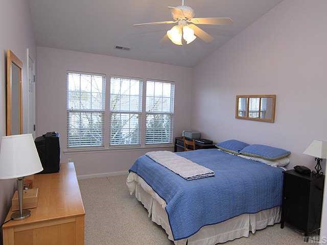 8302 City Loft Court Raleigh, NC 27613 - Photo 7 of 10 a bedroom with a bed and a window