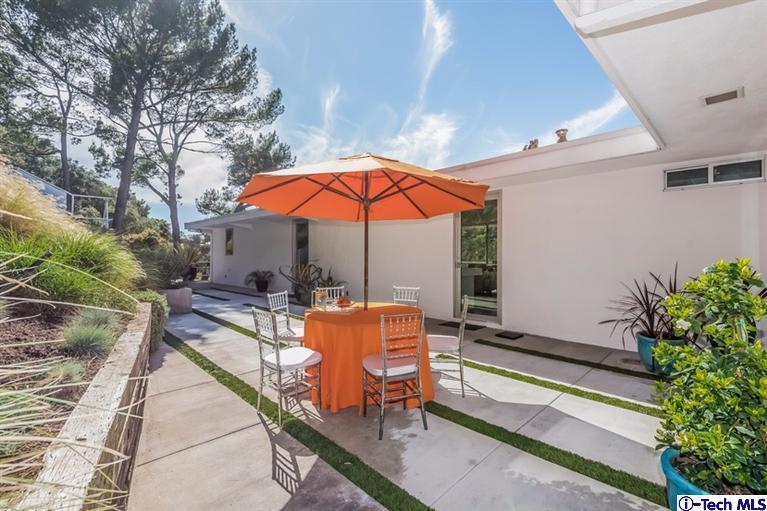 333 Manford Way Pasadena, CA 91105 - Photo 15 of 60 a view of a patio with a table and chairs under an umbrella