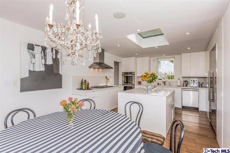 333 Manford Way Pasadena, CA 91105 - Photo 19 of 60 a white kitchen with a refrigerator a stove a sink dishwasher a dining table and chairs with wooden floor